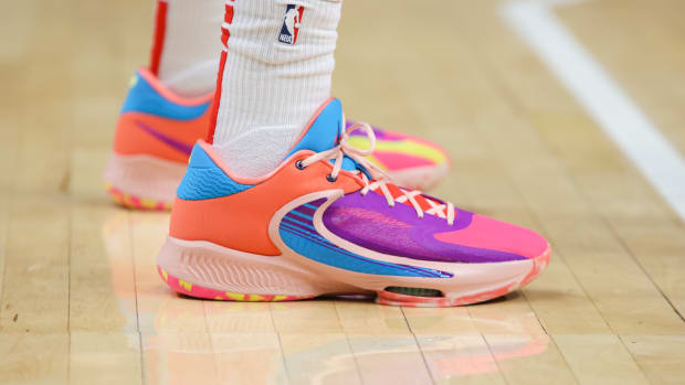 View of purple and orange Nike Zoom Freak shoes.